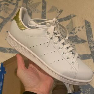 Never been worn Stan Smith sneakers. White with gold accent. Size 7 US